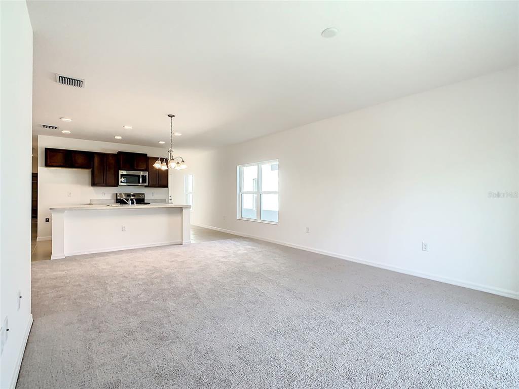1761 Tree Shade Drive Davenport, FL 33837 - Photo 8 of 20 a view of a kitchen with microwave and cabinets
