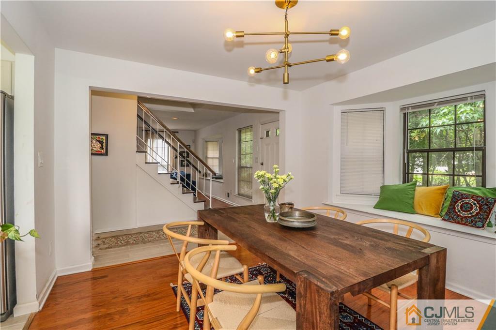2901 Stonehedge Road, Unit 2901 Edison, NJ 08820 - Photo 3 of 25 a view of a dining room with furniture window and wooden floor