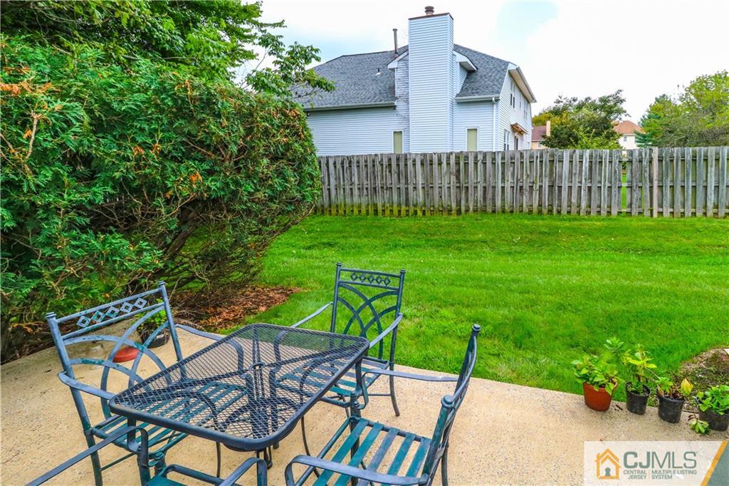 2901 Stonehedge Road, Unit 2901 Edison, NJ 08820 - Photo 23 of 25 a view of a chairs and table in backyard