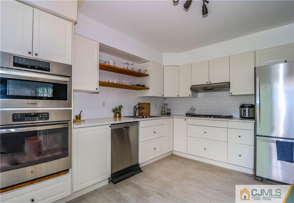 2901 Stonehedge Road, Unit 2901 Edison, NJ 08820 - Photo 7 of 25 a kitchen with cabinets stainless steel appliances and a sink
