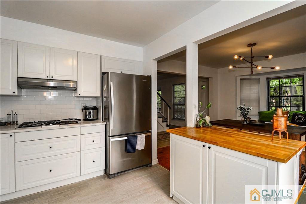 2901 Stonehedge Road, Unit 2901 Edison, NJ 08820 - Photo 9 of 25 a kitchen with stainless steel appliances granite countertop a refrigerator and a sink