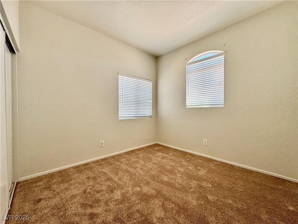1828 Badger Canyon Avenue North Las Vegas, NV 89031 - Photo 8 of 14 Carpeted empty room with baseboards
