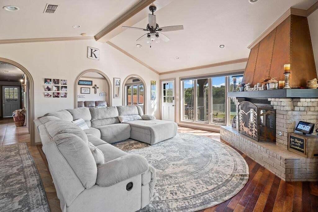 98 South Lakeshore Drive Ransom Canyon, TX 79366 - Photo 17 of 99 a living room with furniture a fireplace and a floor to ceiling window
