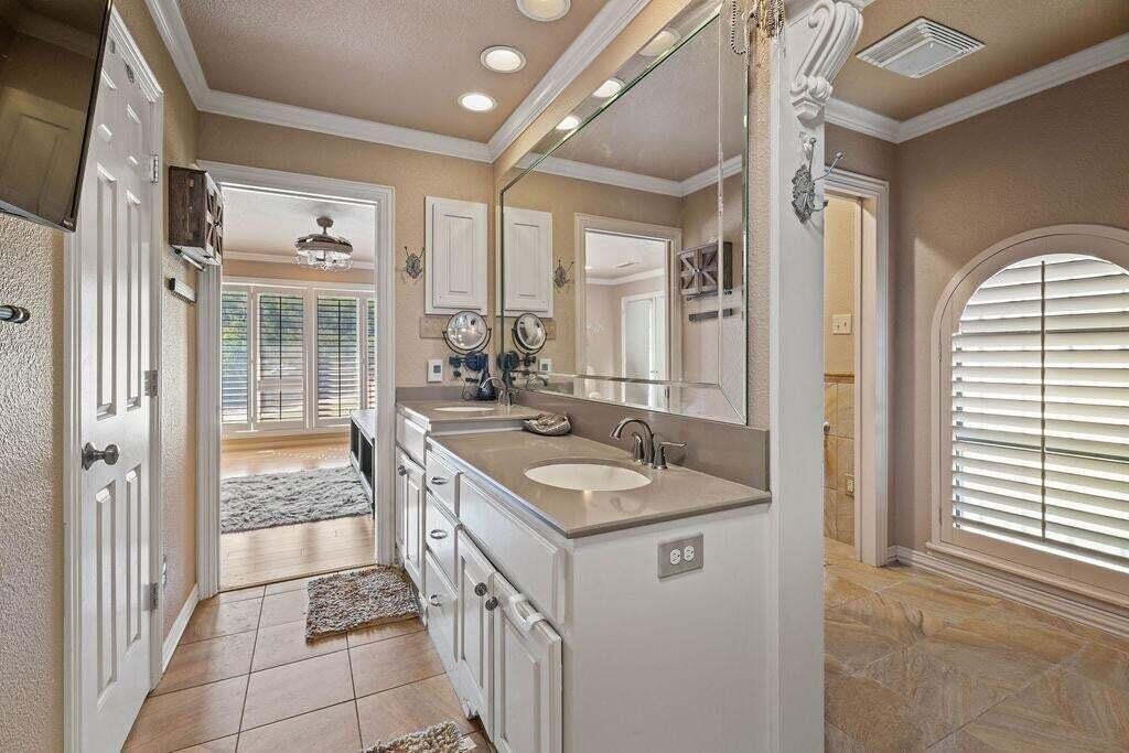 98 South Lakeshore Drive Ransom Canyon, TX 79366 - Photo 31 of 99 a bathroom with a granite countertop sink a mirror and a shower