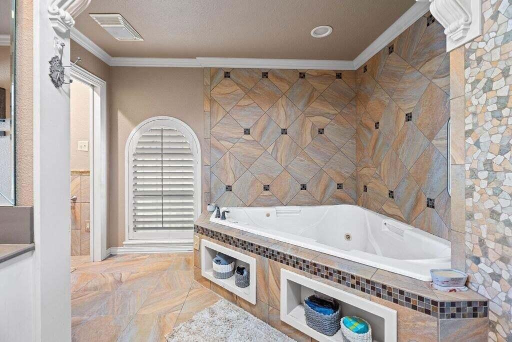 98 South Lakeshore Drive Ransom Canyon, TX 79366 - Photo 33 of 99 a bathroom with a tub a sink and a window