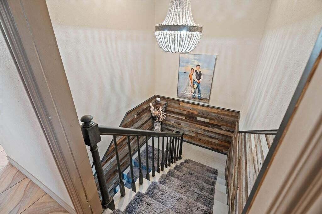 98 South Lakeshore Drive Ransom Canyon, TX 79366 - Photo 35 of 99 a view of a hallway with wooden floor and staircase
