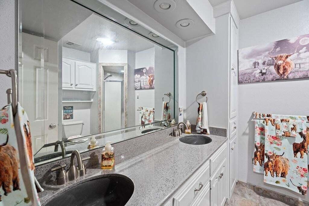98 South Lakeshore Drive Ransom Canyon, TX 79366 - Photo 40 of 99 a bathroom with a double vanity sink