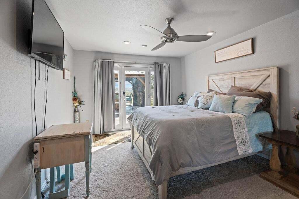 98 South Lakeshore Drive Ransom Canyon, TX 79366 - Photo 41 of 99 a bedroom with a bed and a flat screen tv