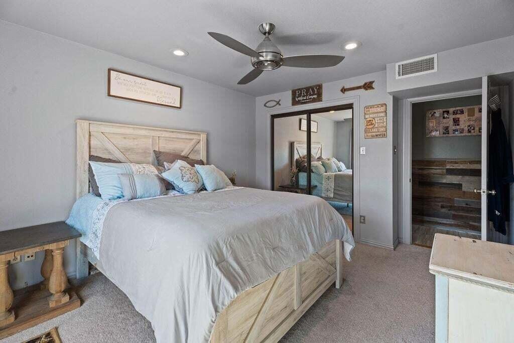 98 South Lakeshore Drive Ransom Canyon, TX 79366 - Photo 42 of 99 a spacious bedroom with a bed and a walk in closet
