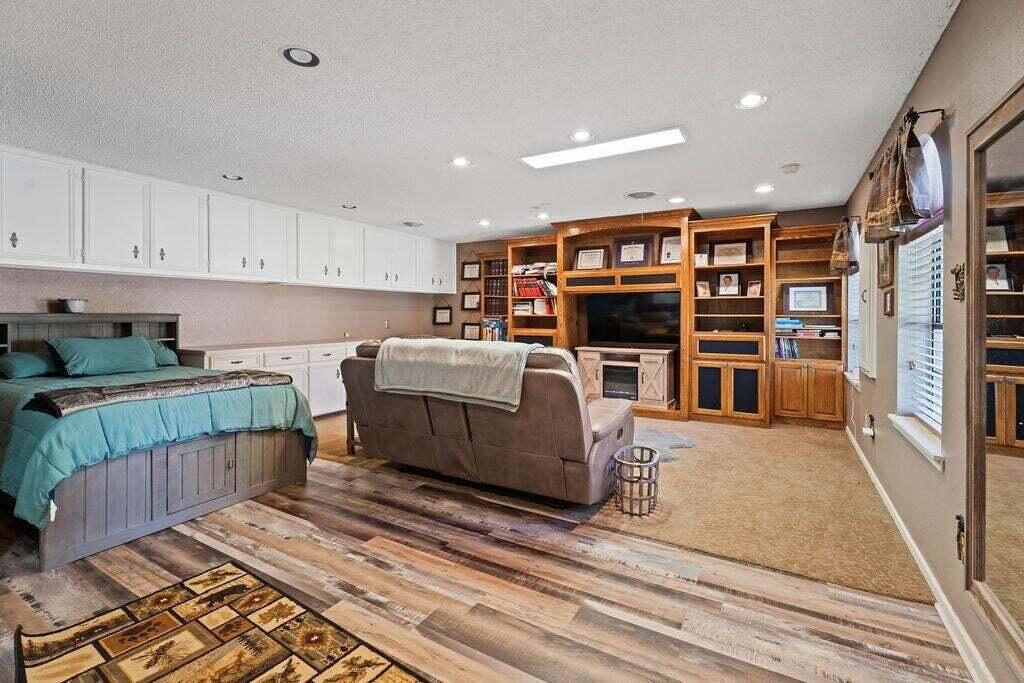 98 South Lakeshore Drive Ransom Canyon, TX 79366 - Photo 45 of 99 a living room with furniture and a book shelf