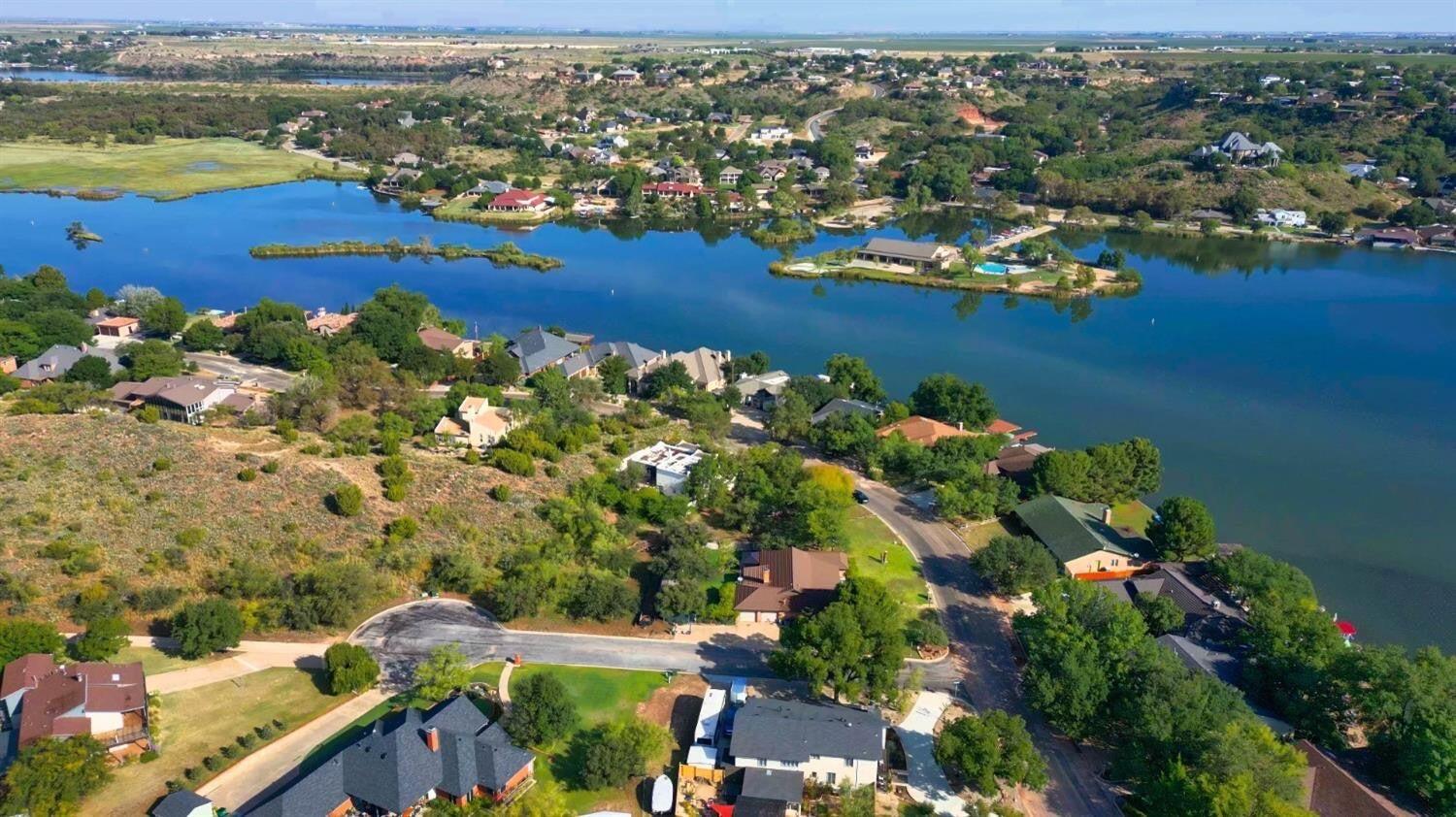 98 South Lakeshore Drive Ransom Canyon, TX 79366 - Photo 76 of 99 an aerial view of lake and residential houses with outdoor space