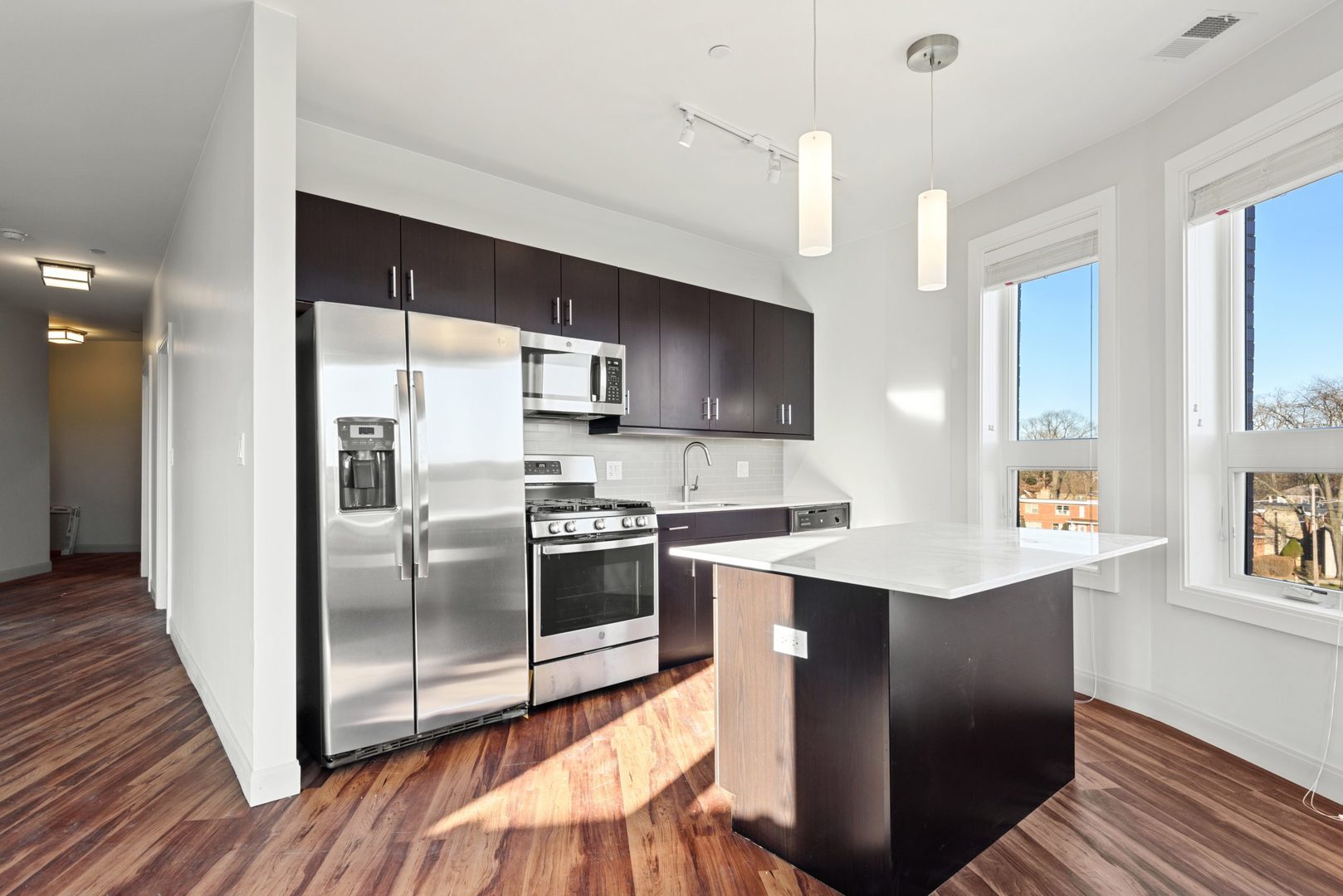 555 Roger Williams Avenue, Unit 405 Highland Park, IL 60035 - Photo 8 of 12 a kitchen with stainless steel appliances a sink a stove a refrigerator cabinets and a dining table