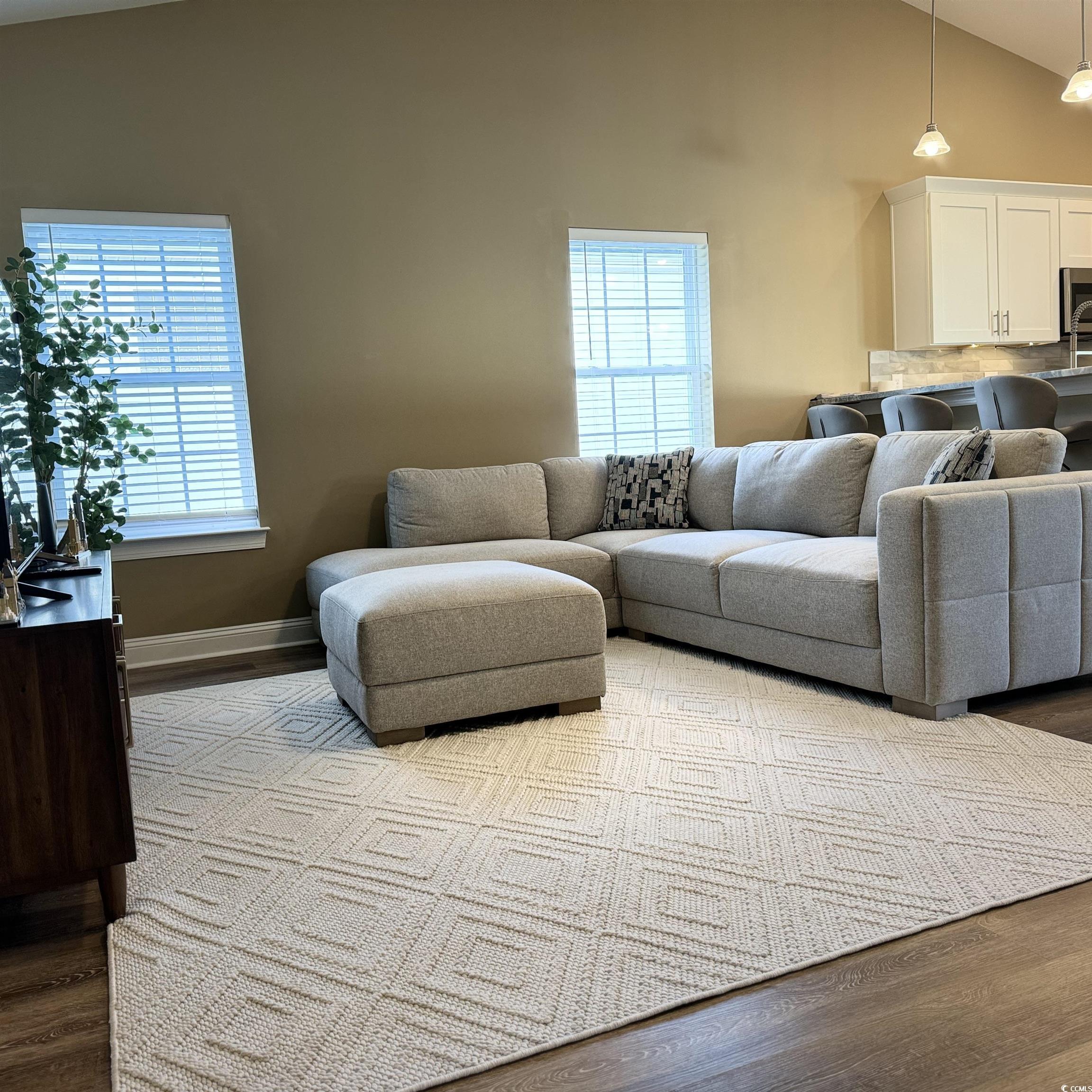 633 11th Avenue South Myrtle Beach, SC 29577 - Photo 11 of 25 Living room with wood finished floors and high vaulted ceiling