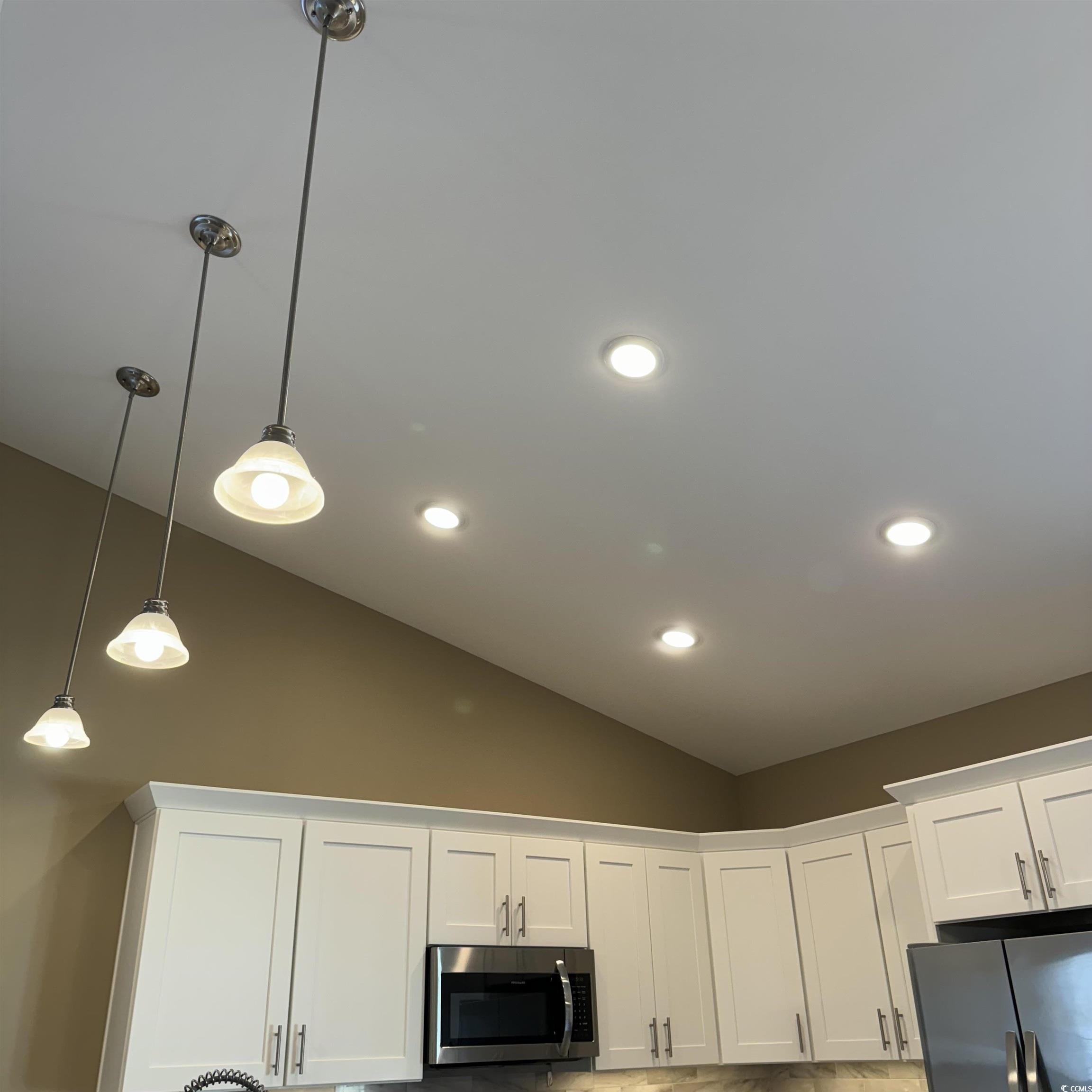 633 11th Avenue South Myrtle Beach, SC 29577 - Photo 12 of 25 Kitchen view of decorative light fixtures, white cabinets, appliances with stainless steel finishes, and recessed lighting