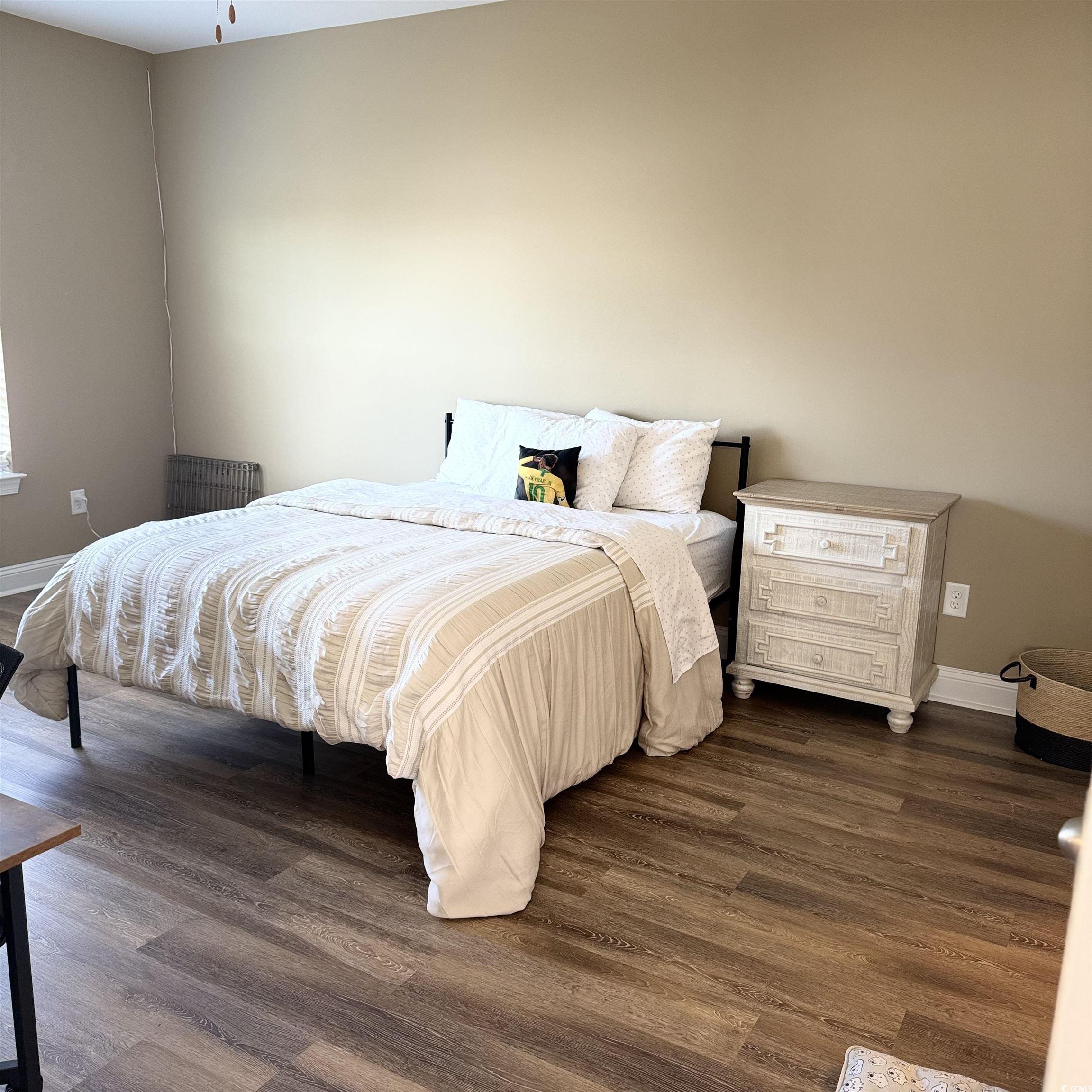 633 11th Avenue South Myrtle Beach, SC 29577 - Photo 16 of 25 Bedroom featuring dark wood-style flooring and baseboards