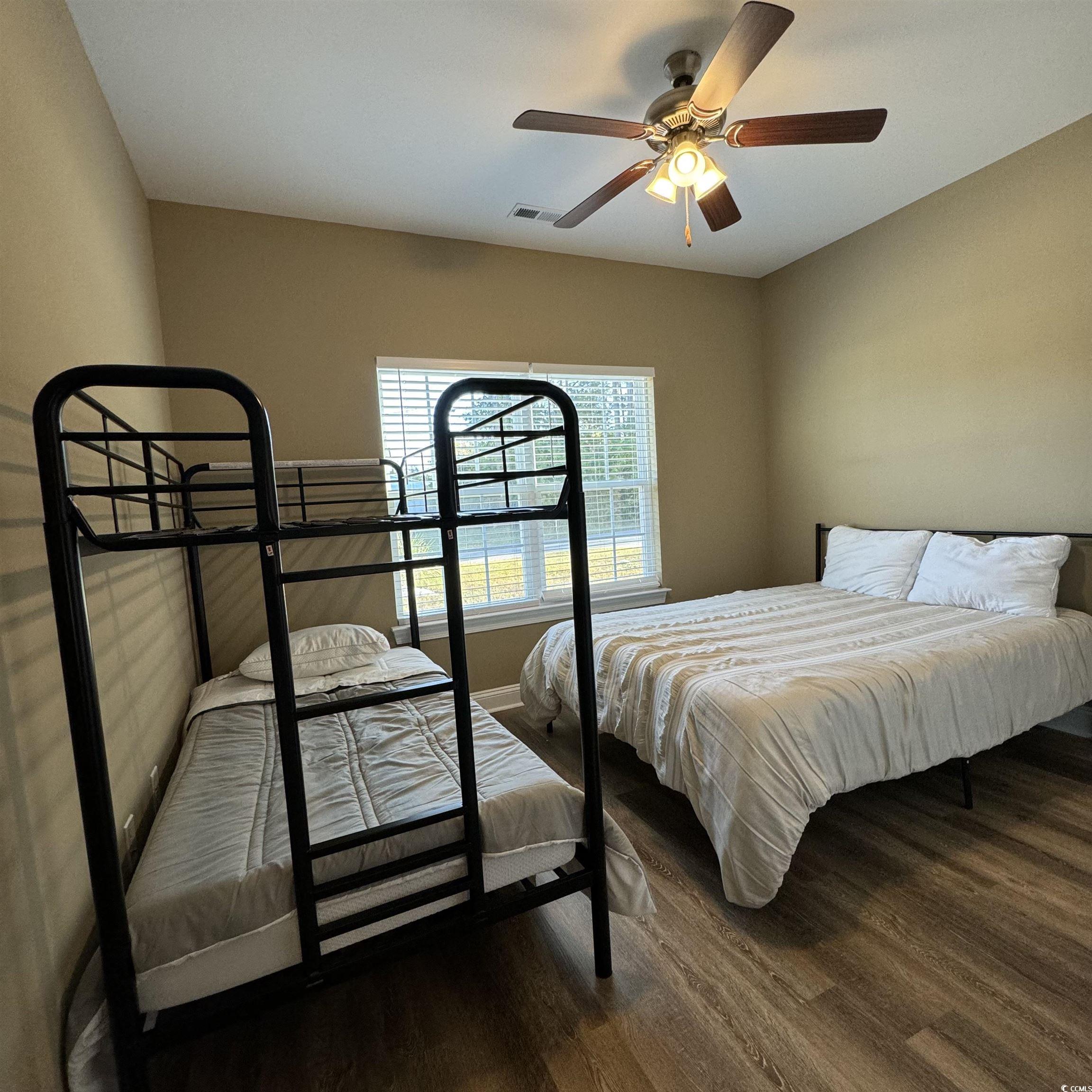 633 11th Avenue South Myrtle Beach, SC 29577 - Photo 17 of 25 Bedroom with dark wood-style flooring and ceiling fan