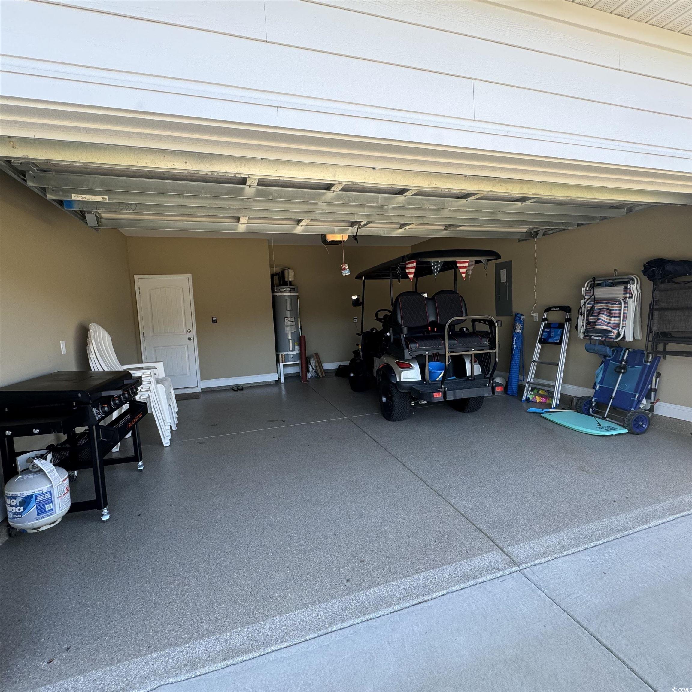 633 11th Avenue South Myrtle Beach, SC 29577 - Photo 23 of 25 Garage featuring electric water heater and baseboards