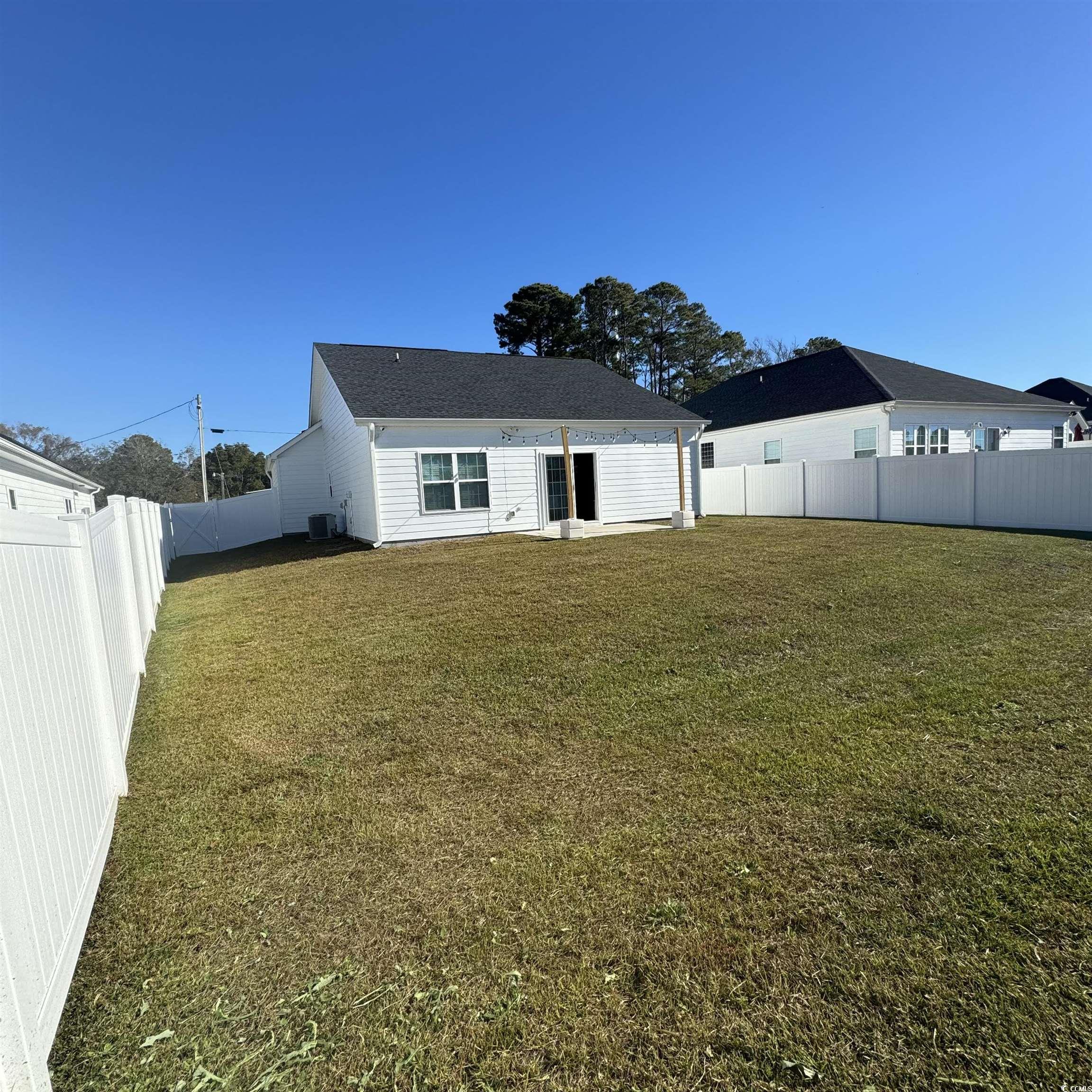 633 11th Avenue South Myrtle Beach, SC 29577 - Photo 4 of 25 Back of property featuring a patio area and a fenced backyard