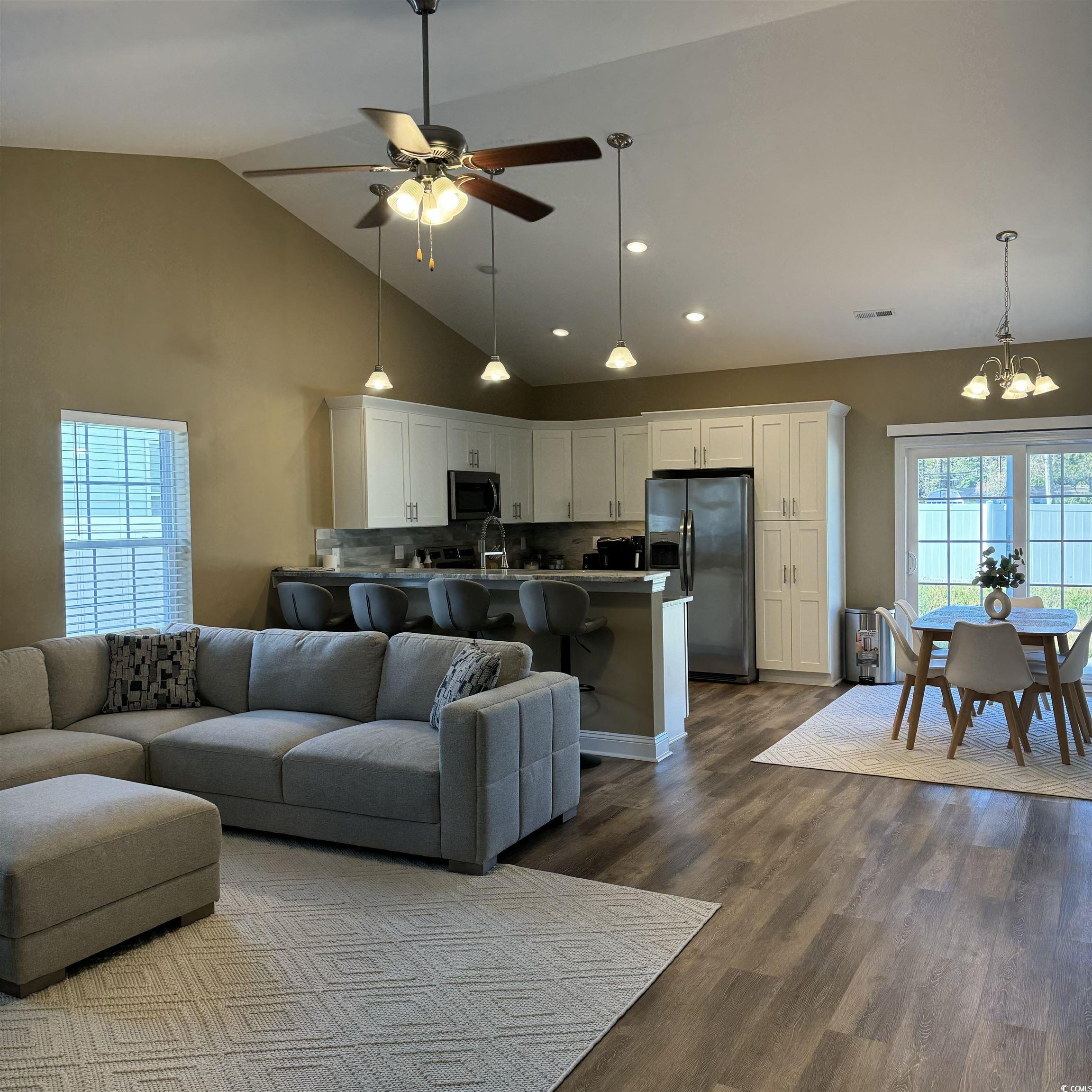 633 11th Avenue South Myrtle Beach, SC 29577 - Photo 9 of 25 Living area with high vaulted ceiling, dark wood-style flooring, ceiling fan, a chandelier, and recessed lighting