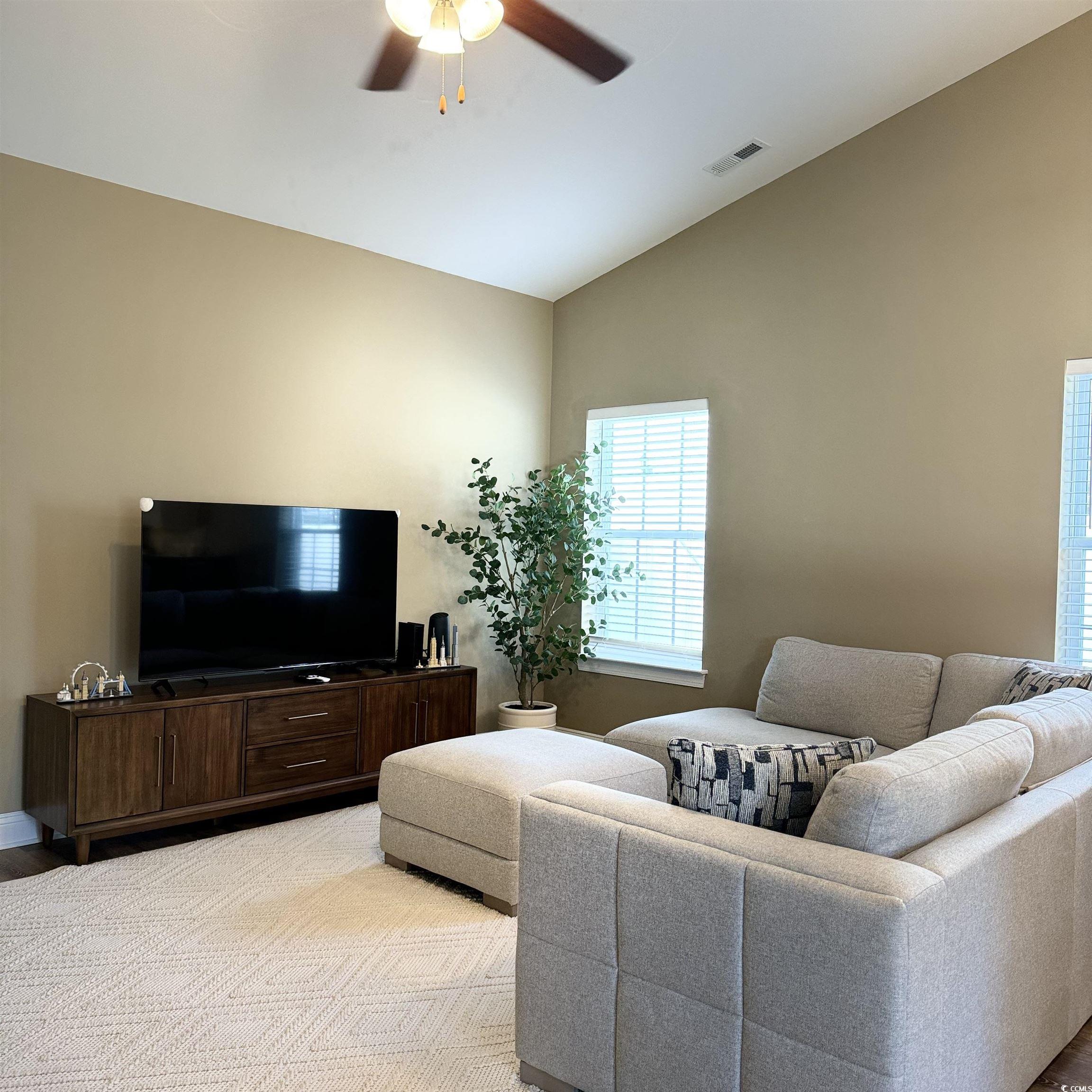 633 11th Avenue South Myrtle Beach, SC 29577 - Photo 10 of 25 Living area featuring lofted ceiling, light wood-type flooring, and ceiling fan