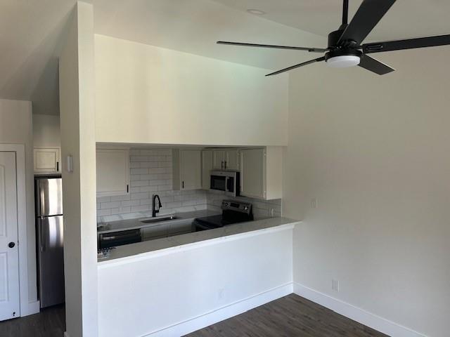 6108 Abrams Road, Unit 127 Dallas, TX 75231 - Photo 2 of 5 a kitchen with a sink and a refrigerator