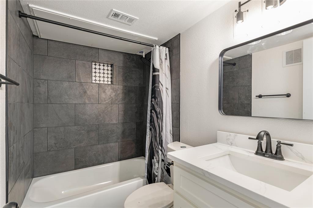 6108 Abrams Road, Unit 127 Dallas, TX 75231 - Photo 3 of 5 a bathroom with a sink and a mirror