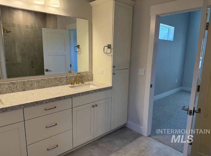 665 West Wrangler Street Meridian, ID 83646 - Photo 9 of 18 Dual vanity with integrated sinks and a stone-finish countertop