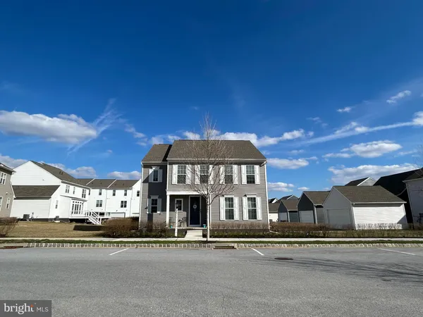 a view of a big house next to a road