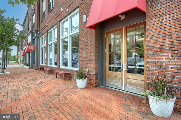 a view of a building with sitting area and porch