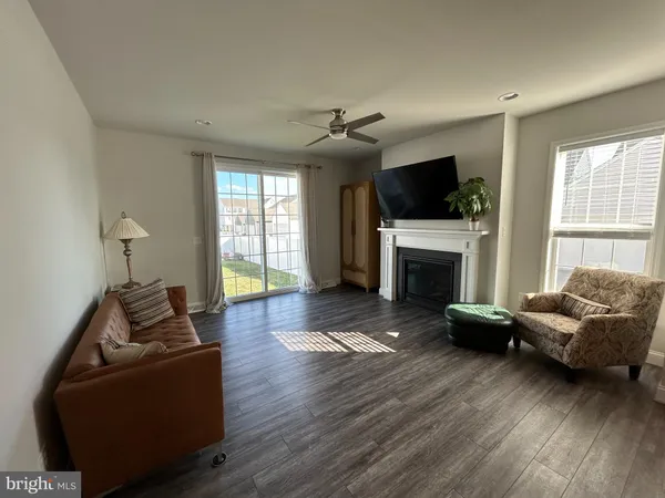 a living room with furniture flat screen tv and a fireplace