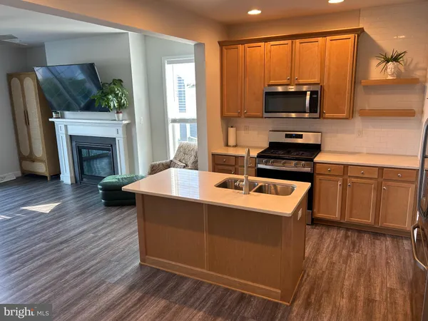 a kitchen with a sink stove and microwave