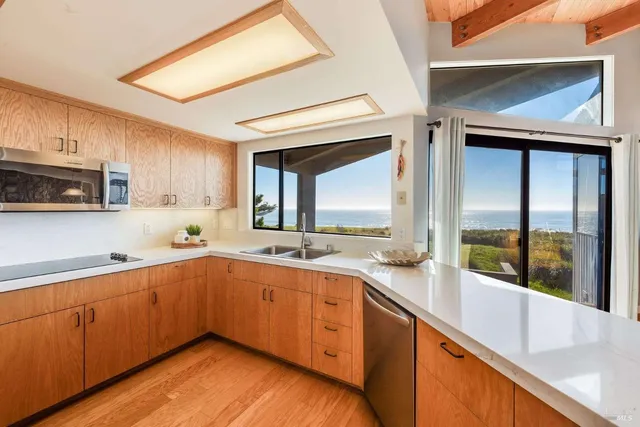 a large kitchen with a sink and cabinets