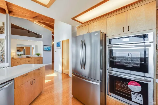 a kitchen with stainless steel appliances granite countertop a refrigerator and a stove