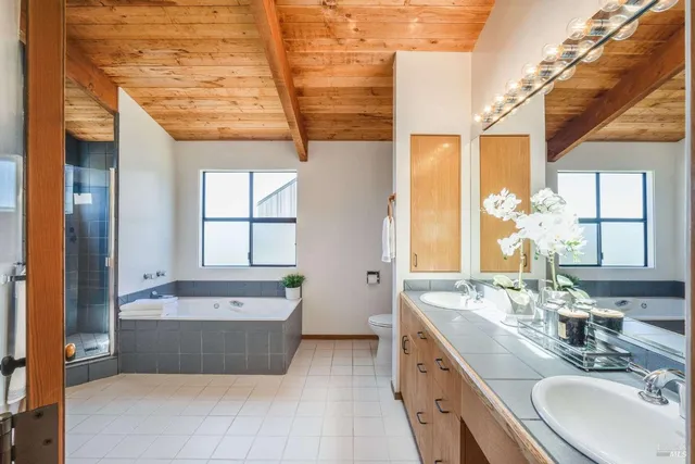 a bedroom with a bed and a mirror