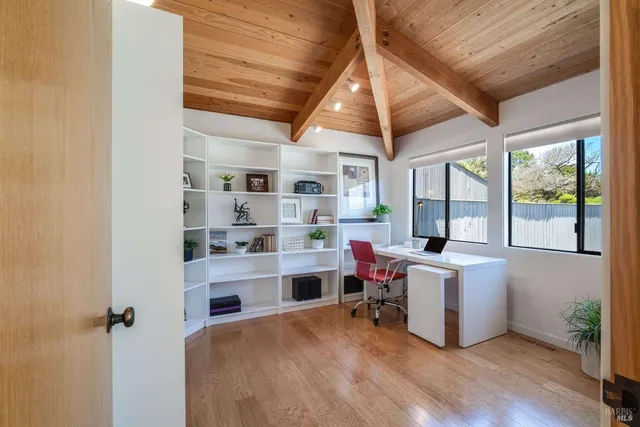 a yellow house with trees in front of it