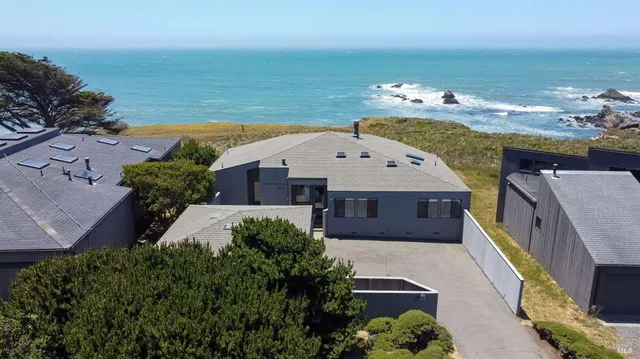 an aerial view of a house with a ocean view