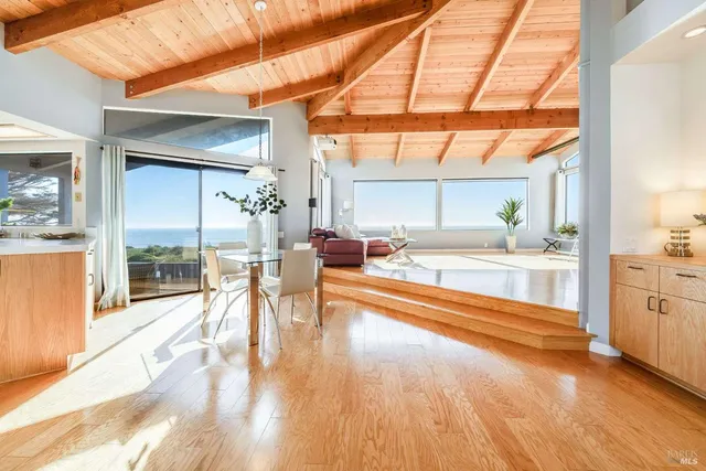 a view of a living room and kitchen area