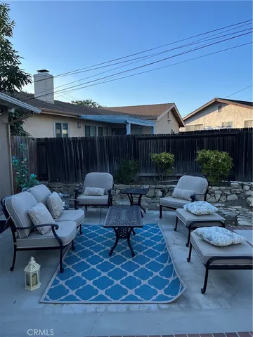 a view of patio with a table and chairs under an umbrella