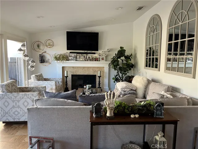 a living room with furniture a fireplace and a flat screen tv