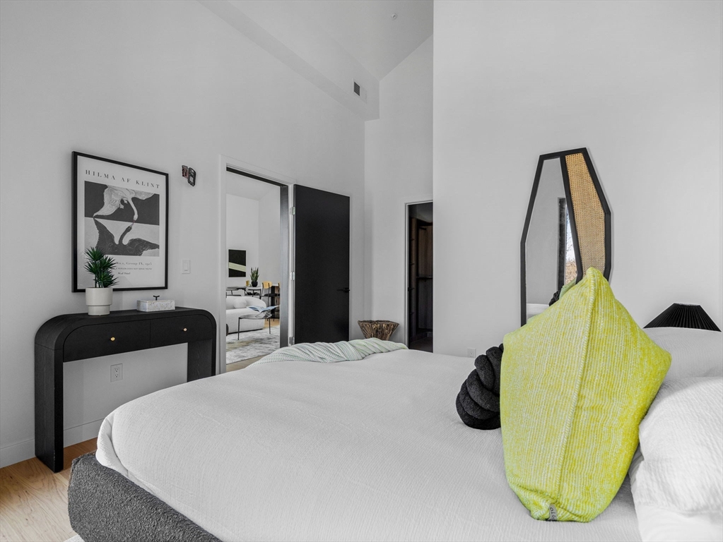 22 High Street, Unit 101 Boston, MA 02122 - Photo 7 of 10 a bedroom with a bed and wooden floor