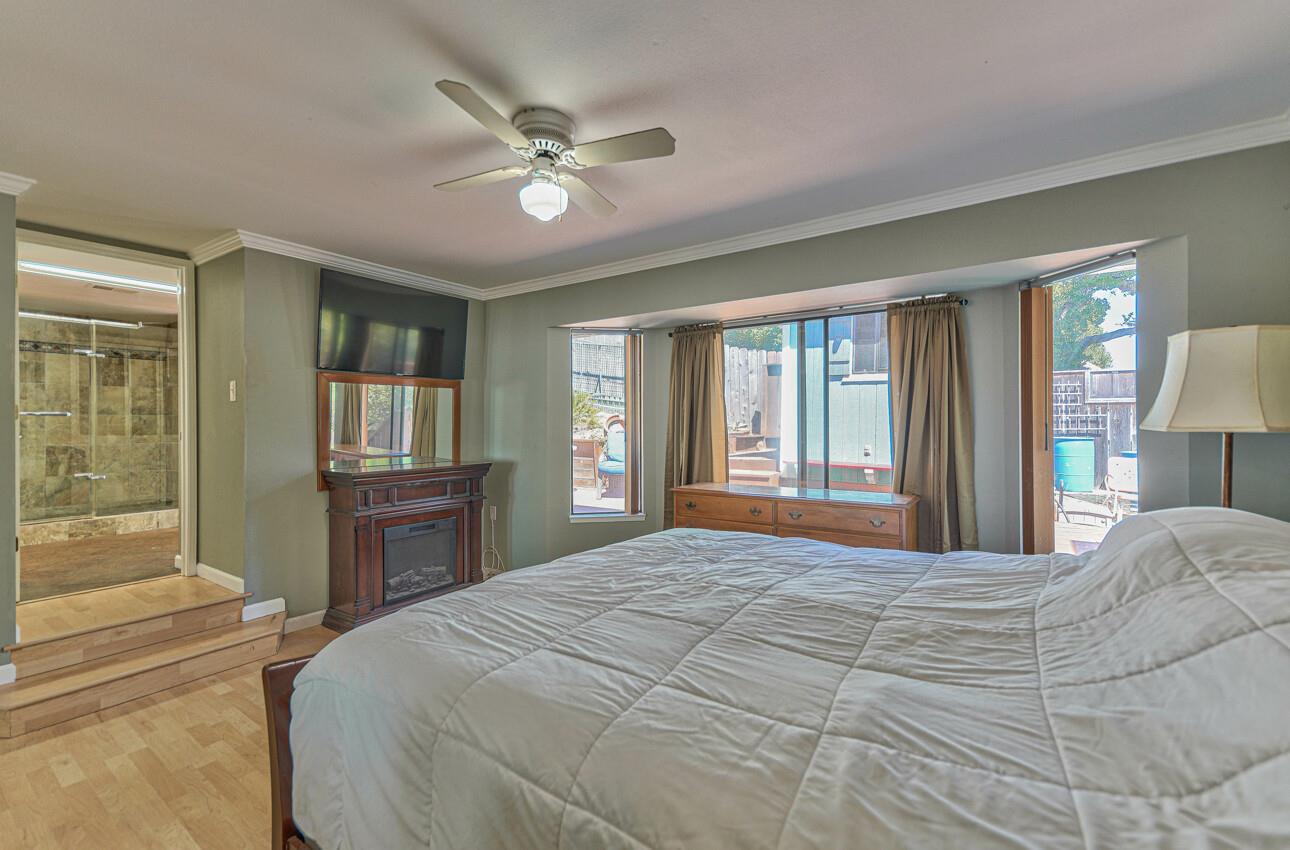 19205 Marjorie Road Salinas, CA 93907 - Photo 14 of 30 a bedroom with a large bed and a chandelier