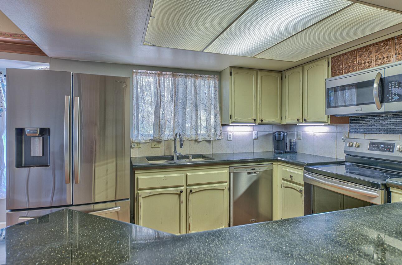 19205 Marjorie Road Salinas, CA 93907 - Photo 9 of 30 a kitchen with a sink stove and cabinets