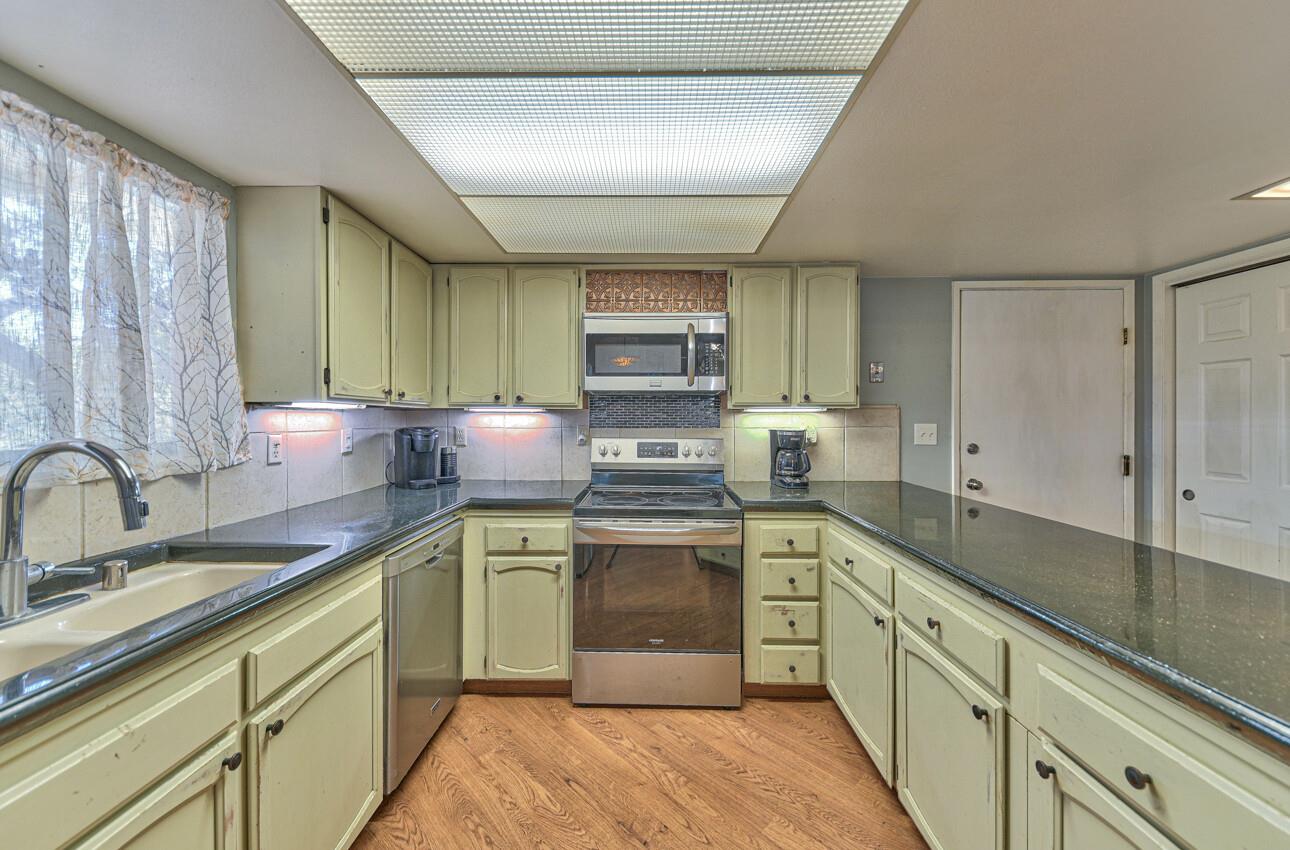 19205 Marjorie Road Salinas, CA 93907 - Photo 10 of 30 a kitchen with stainless steel appliances granite countertop a sink stove and cabinets
