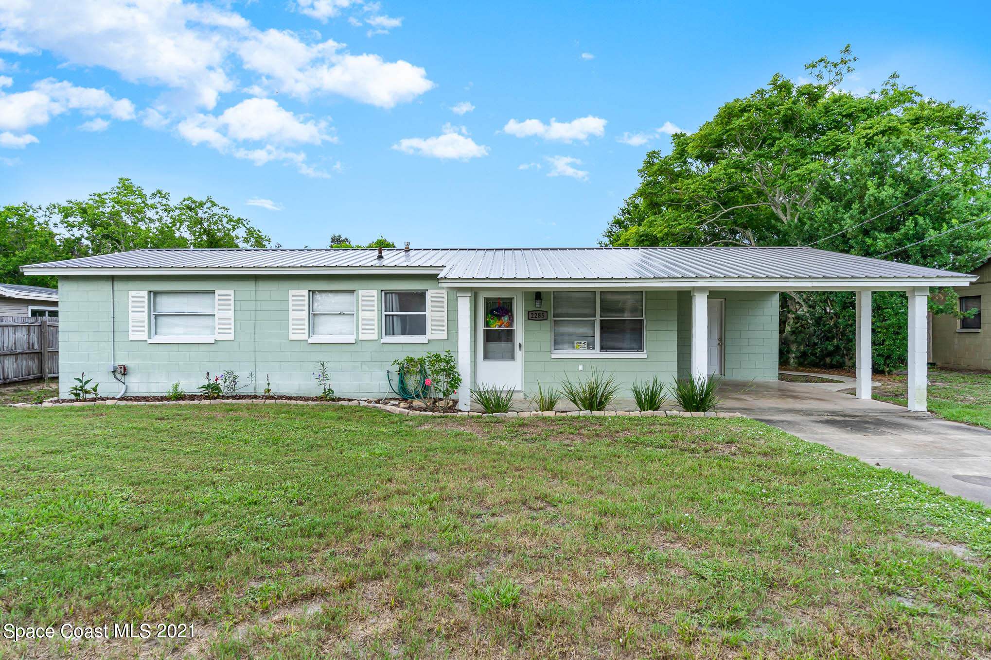 2285 Dolphin Road Titusville, FL 32780 - Photo 1 of 27 front view of a house with a yard