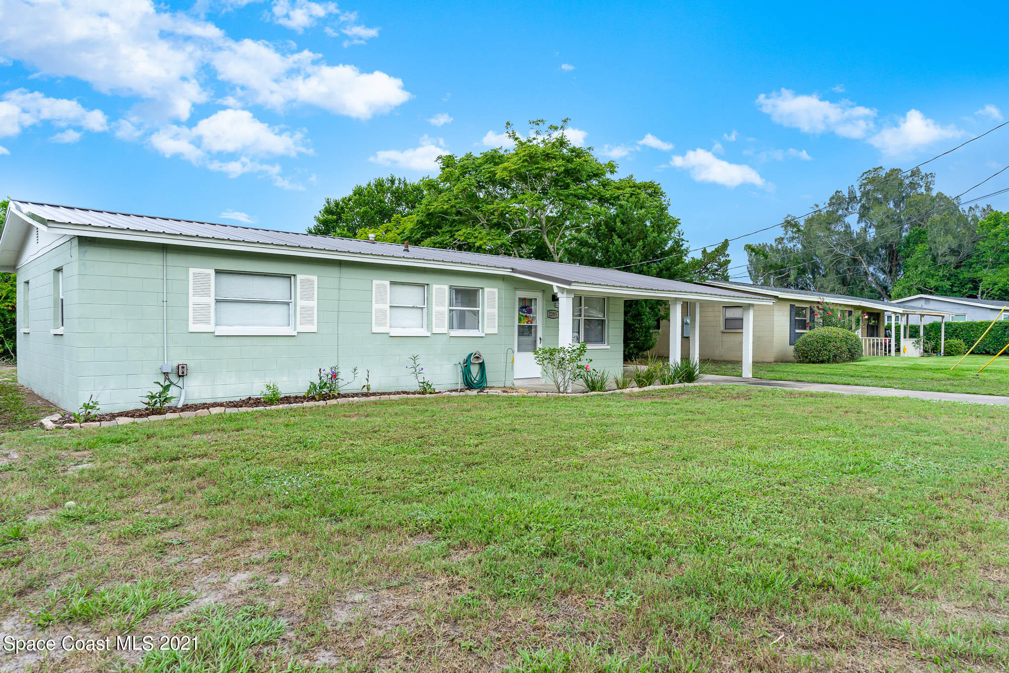 2285 Dolphin Road Titusville, FL 32780 - Photo 2 of 27 a front view of house with yard and green space