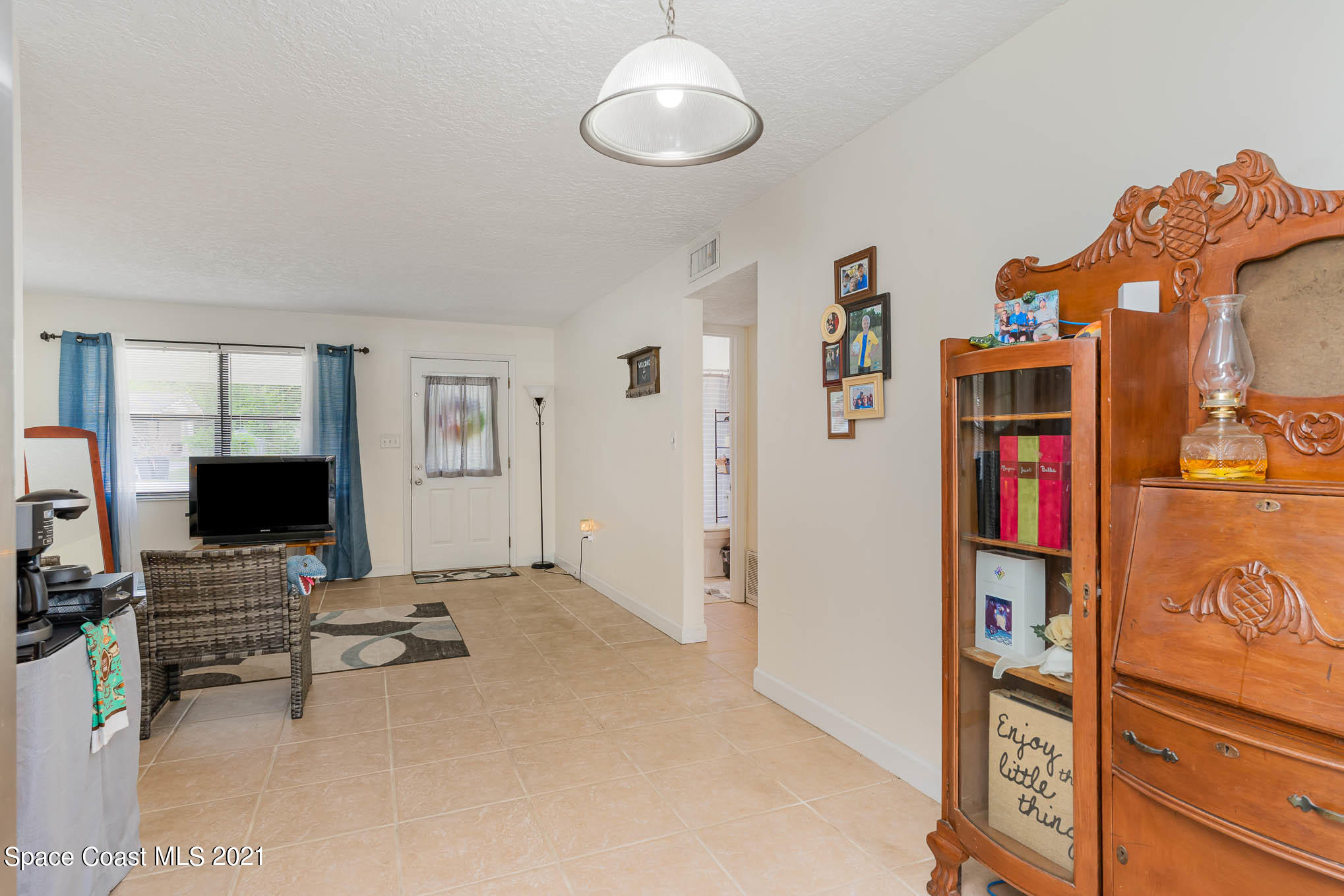 2285 Dolphin Road Titusville, FL 32780 - Photo 12 of 27 a living room with furniture and a flat screen tv