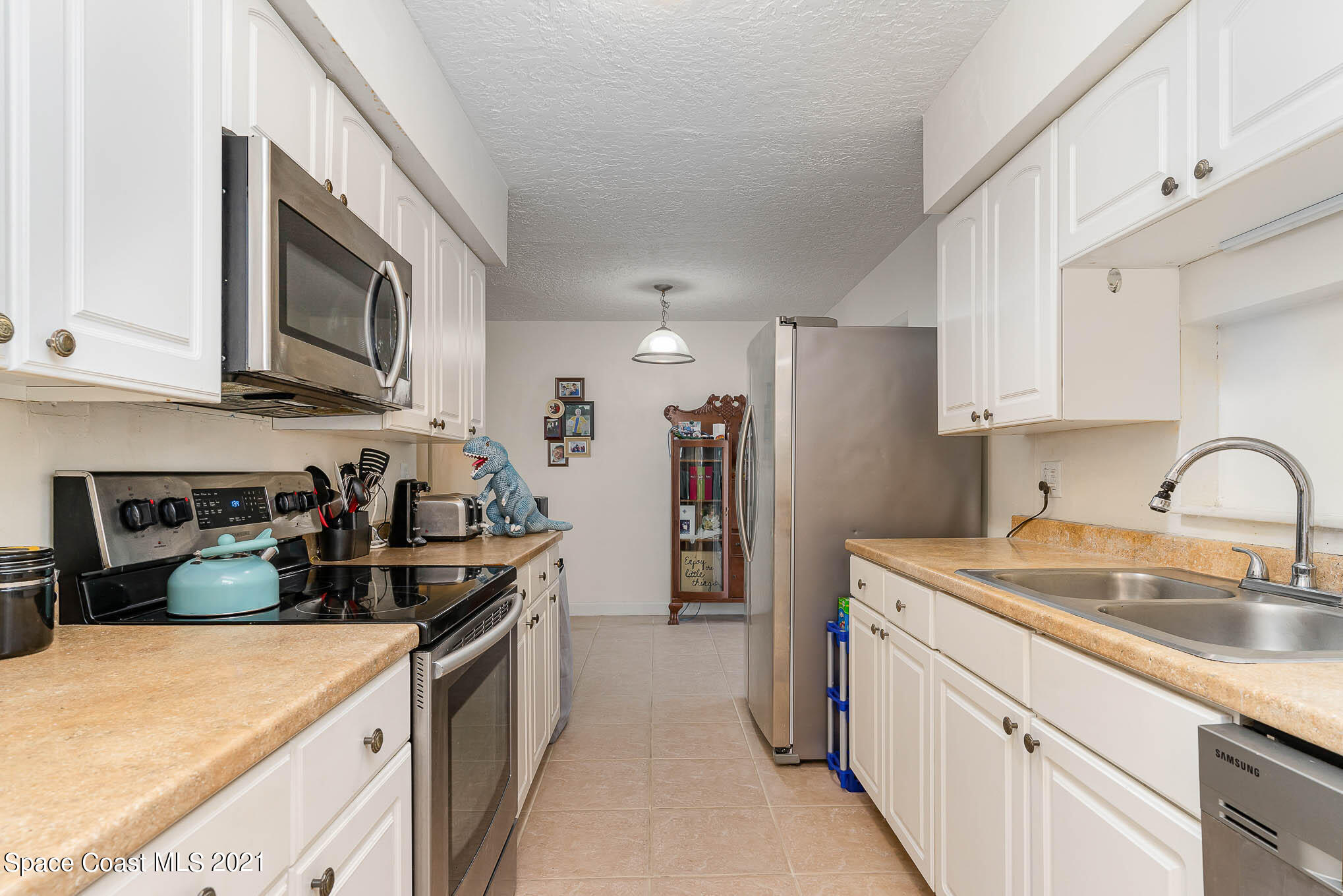 2285 Dolphin Road Titusville, FL 32780 - Photo 14 of 27 a kitchen with stainless steel appliances granite countertop a sink stove and refrigerator