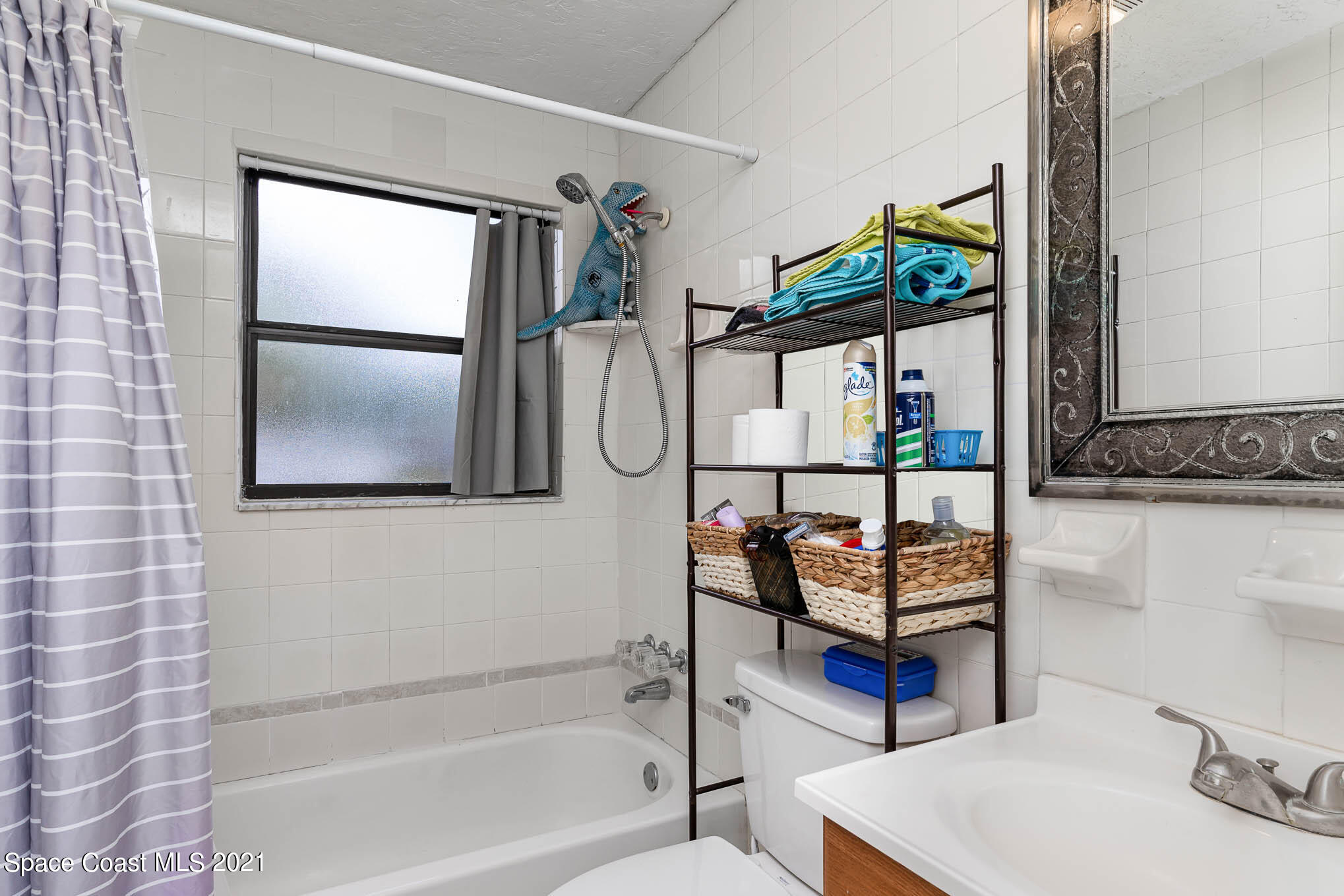 2285 Dolphin Road Titusville, FL 32780 - Photo 17 of 27 a bathroom with a sink toilet and shower