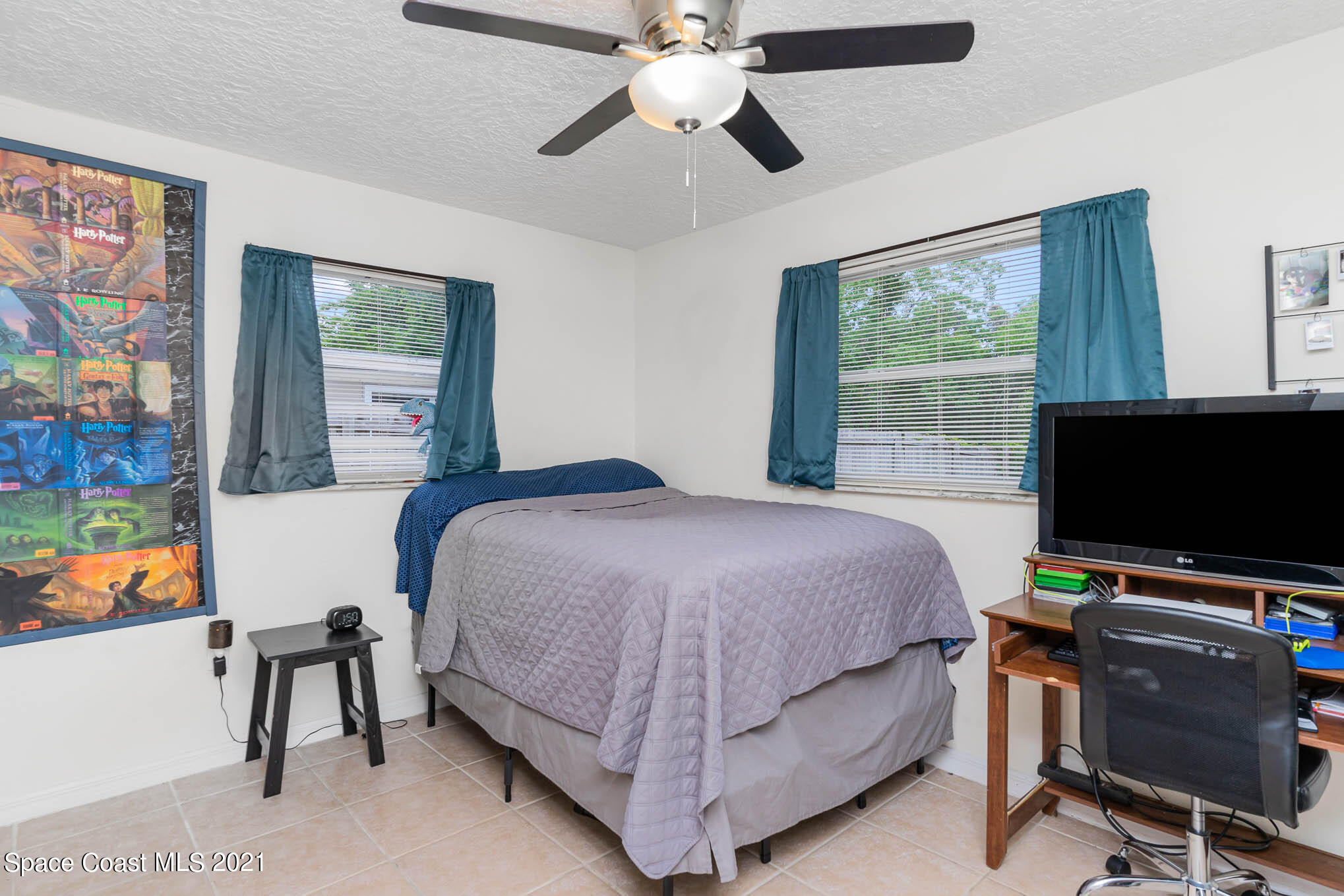 2285 Dolphin Road Titusville, FL 32780 - Photo 20 of 27 a bedroom with a bed and a flat screen tv