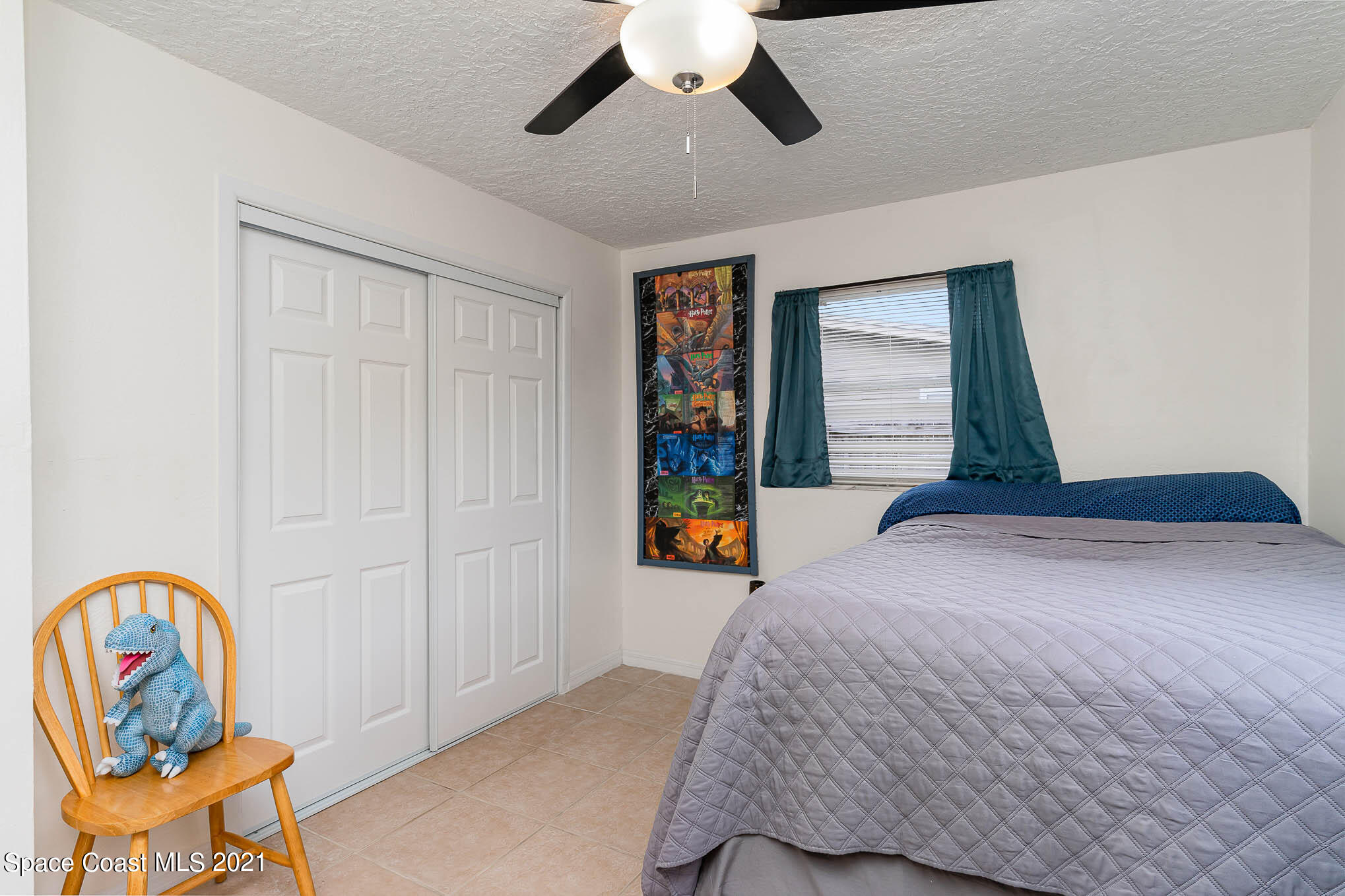2285 Dolphin Road Titusville, FL 32780 - Photo 21 of 27 a bedroom with a bed and a painting on the wall